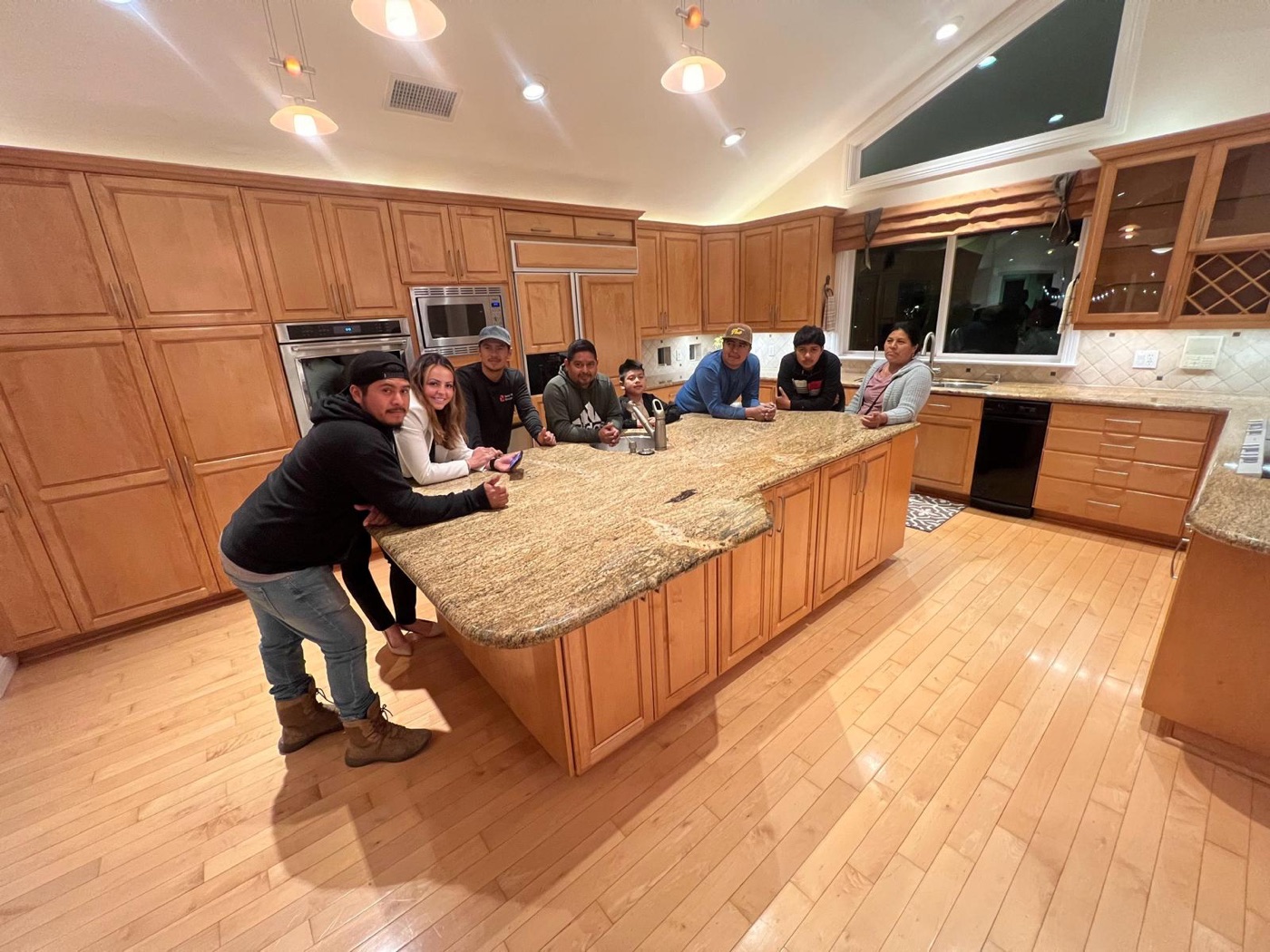 Paula with a family around a large kitchen island