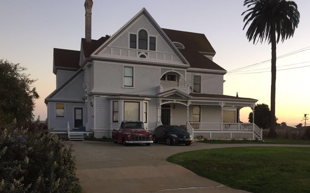 The front of an older family house at sunset