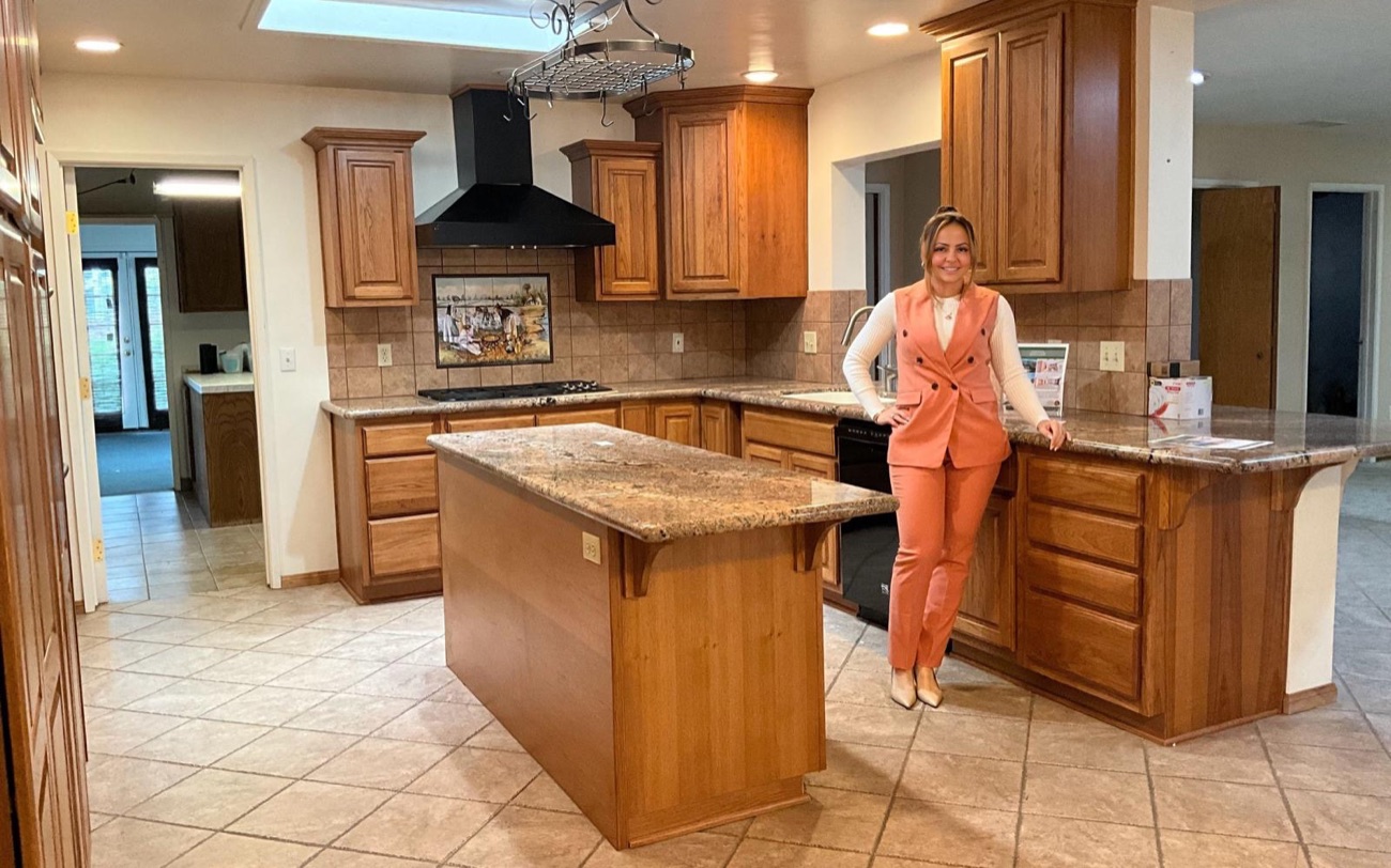 A dated kitchen with wood cabinets and tile floor